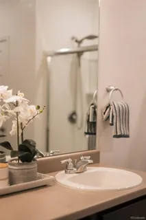 a bedroom with a bed and a potted plant