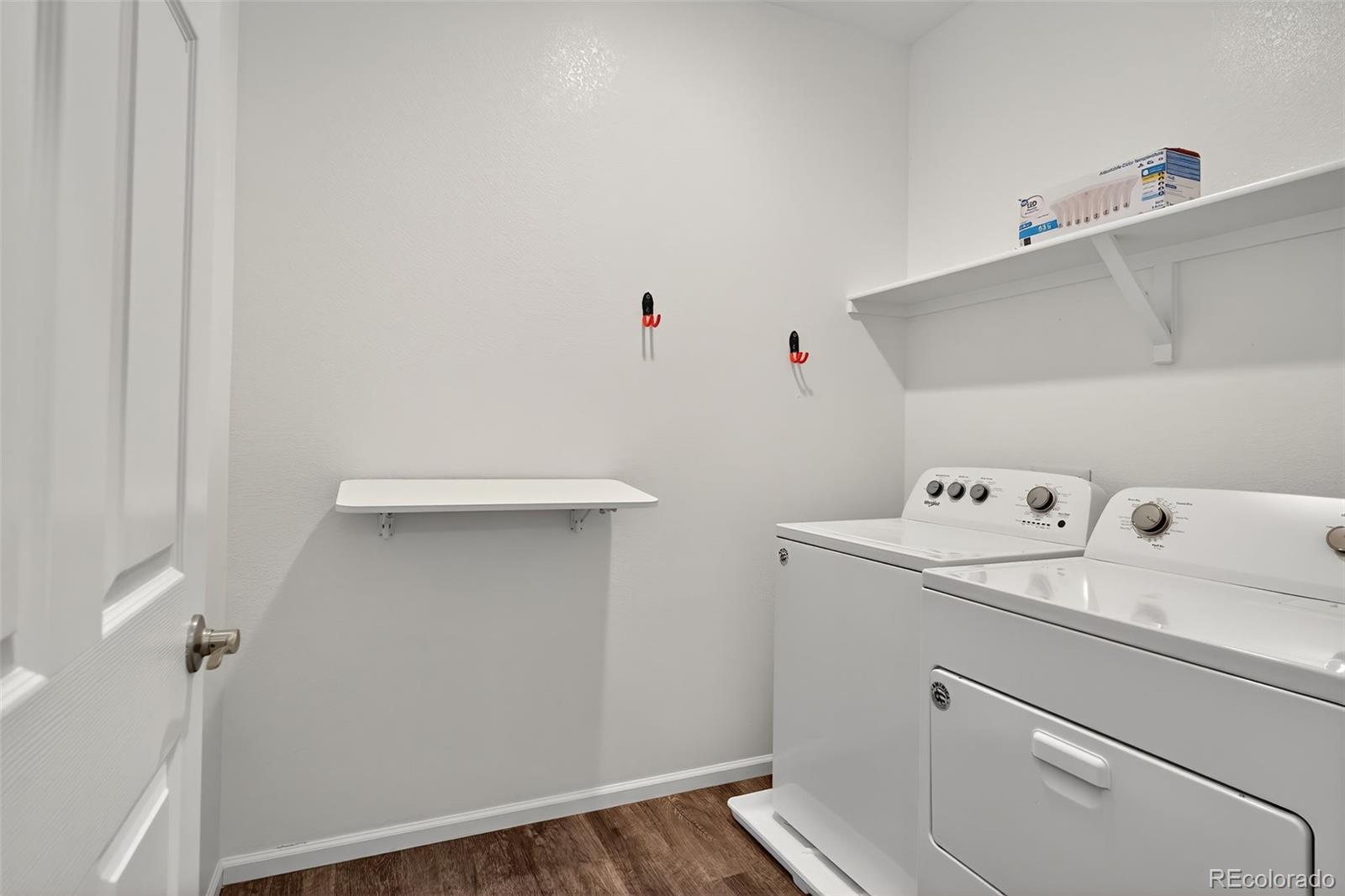 22603 East Radcliff Drive Aurora, CO 80015 - Photo 29 of 42 a view of storage and utility room with washer and dryer