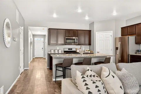 a kitchen with stainless steel appliances granite countertop a refrigerator stove microwave and sink