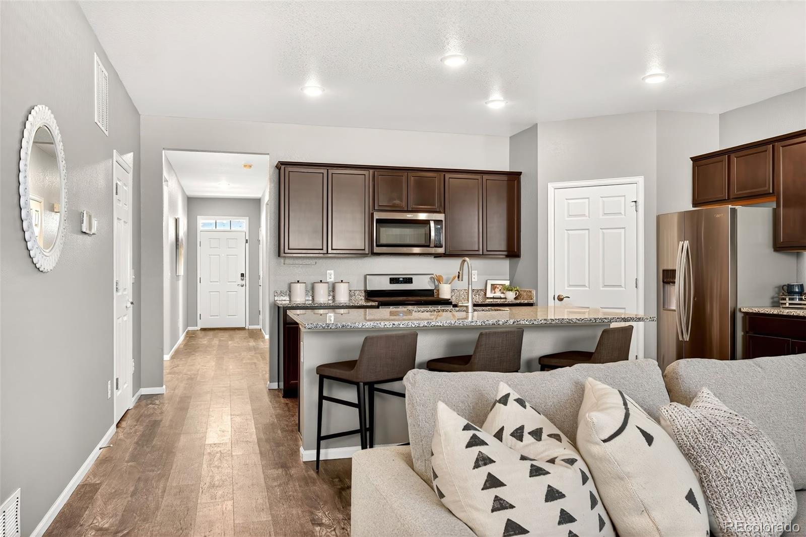 22603 East Radcliff Drive Aurora, CO 80015 - Photo 6 of 42 a kitchen with stainless steel appliances granite countertop a refrigerator stove microwave and sink