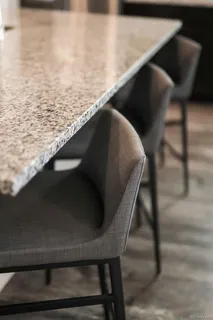 a kitchen with sink refrigerator dining table and chairs