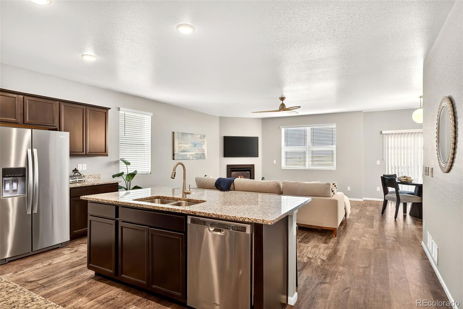 22603 East Radcliff Drive Aurora, CO 80015 - Photo 9 of 42 a kitchen with sink refrigerator dining table and chairs