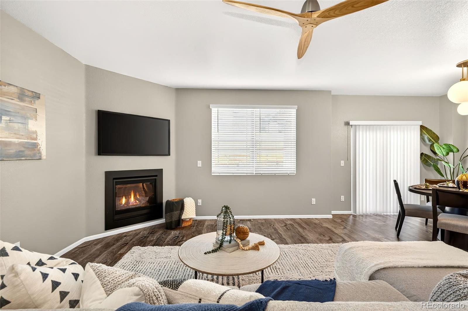 22603 East Radcliff Drive Aurora, CO 80015 - Photo 10 of 42 a living room with furniture and a fireplace