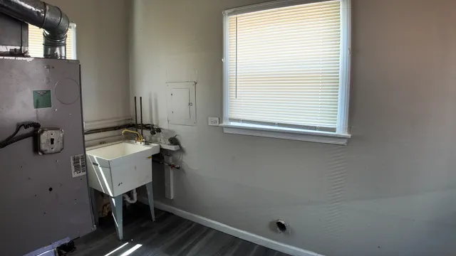 a bathroom with a sink a mirror and a window