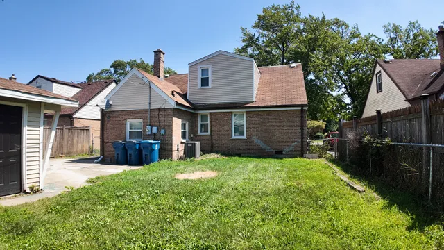 a view of a house with a yard and sitting area
