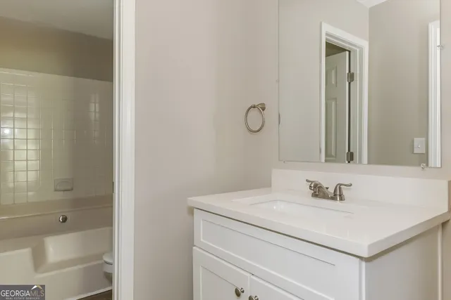 a bathroom with a sink toilet vanity and shower