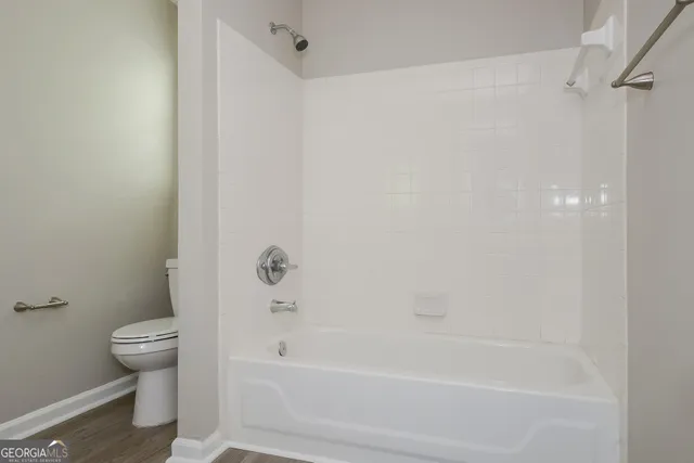 a bathroom with a bathtub and a toilet