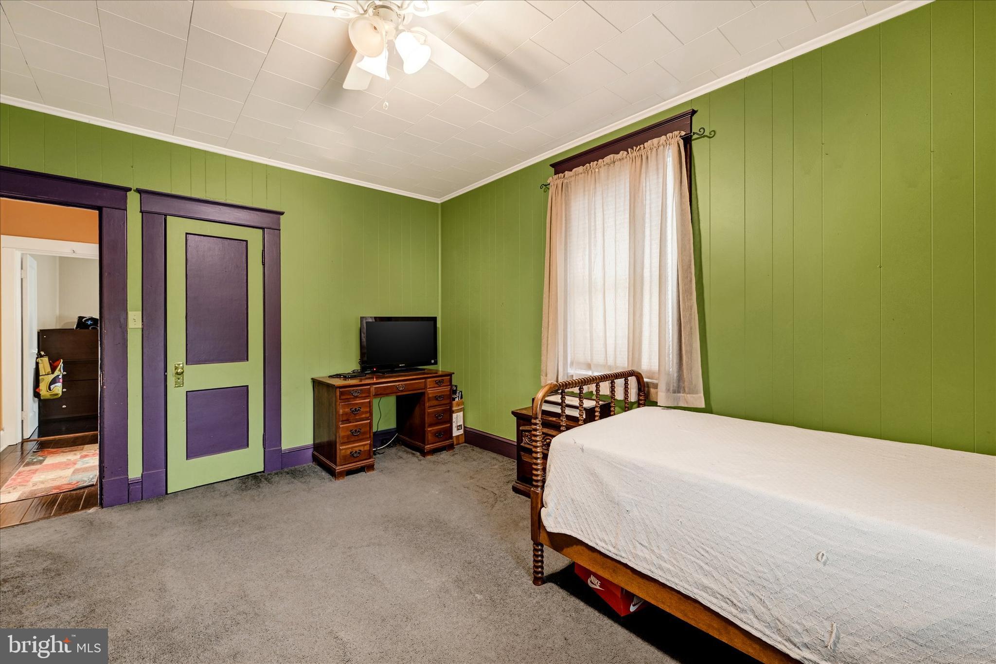 4630 Magnolia Avenue Baltimore, MD 21227 - Photo 15 of 31 a bedroom with a bed and a television