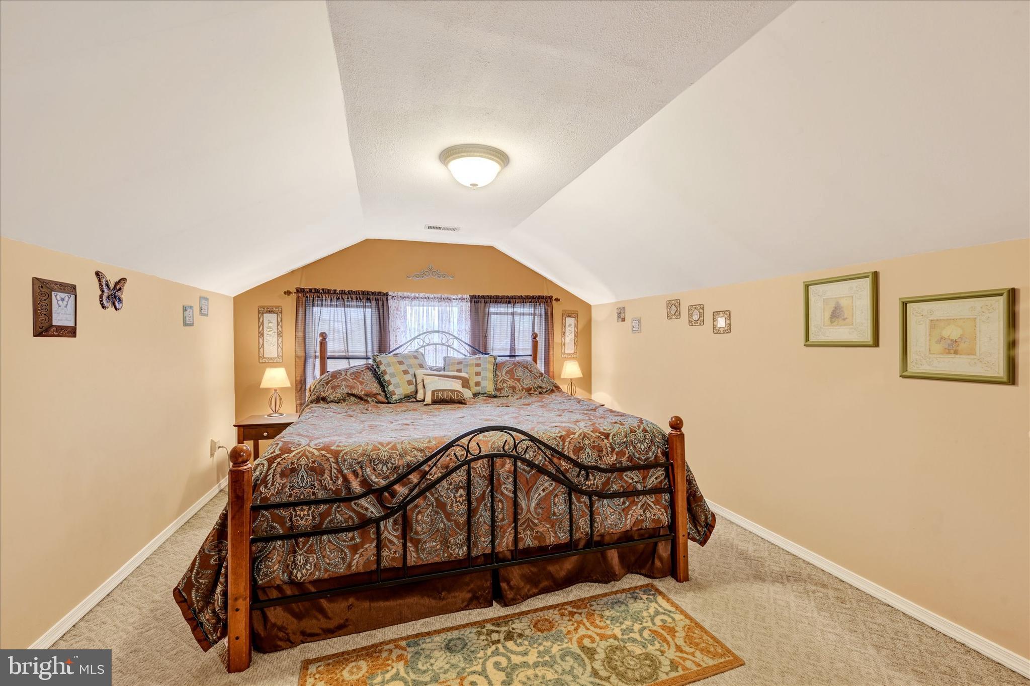 4630 Magnolia Avenue Baltimore, MD 21227 - Photo 20 of 31 a bedroom with a bed and a window