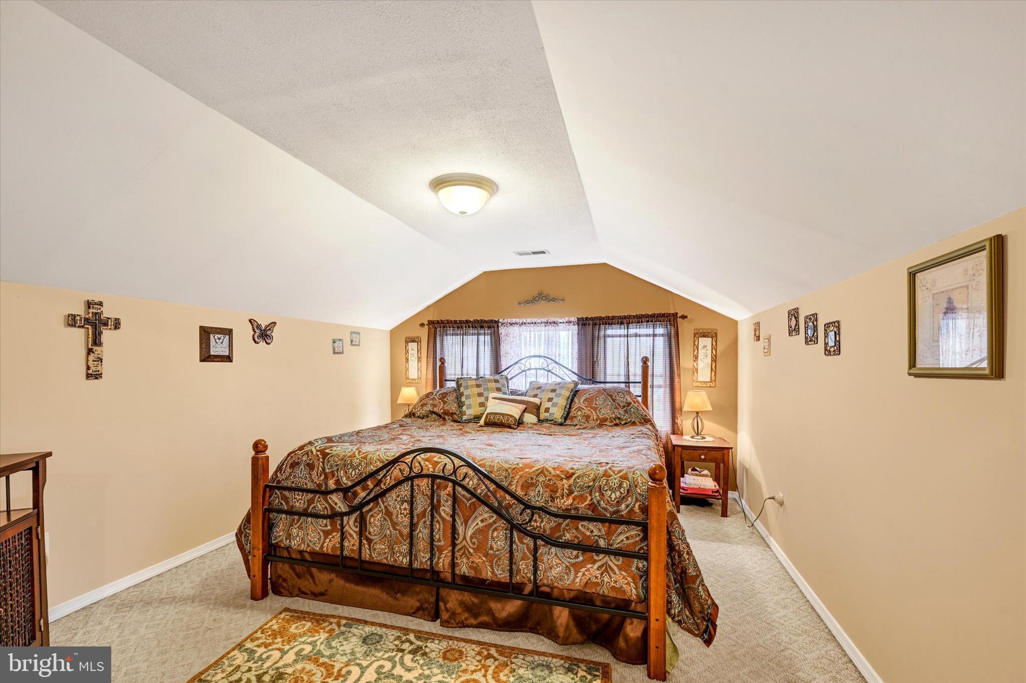 4630 Magnolia Avenue Baltimore, MD 21227 - Photo 21 of 31 a bedroom with a bed and a table