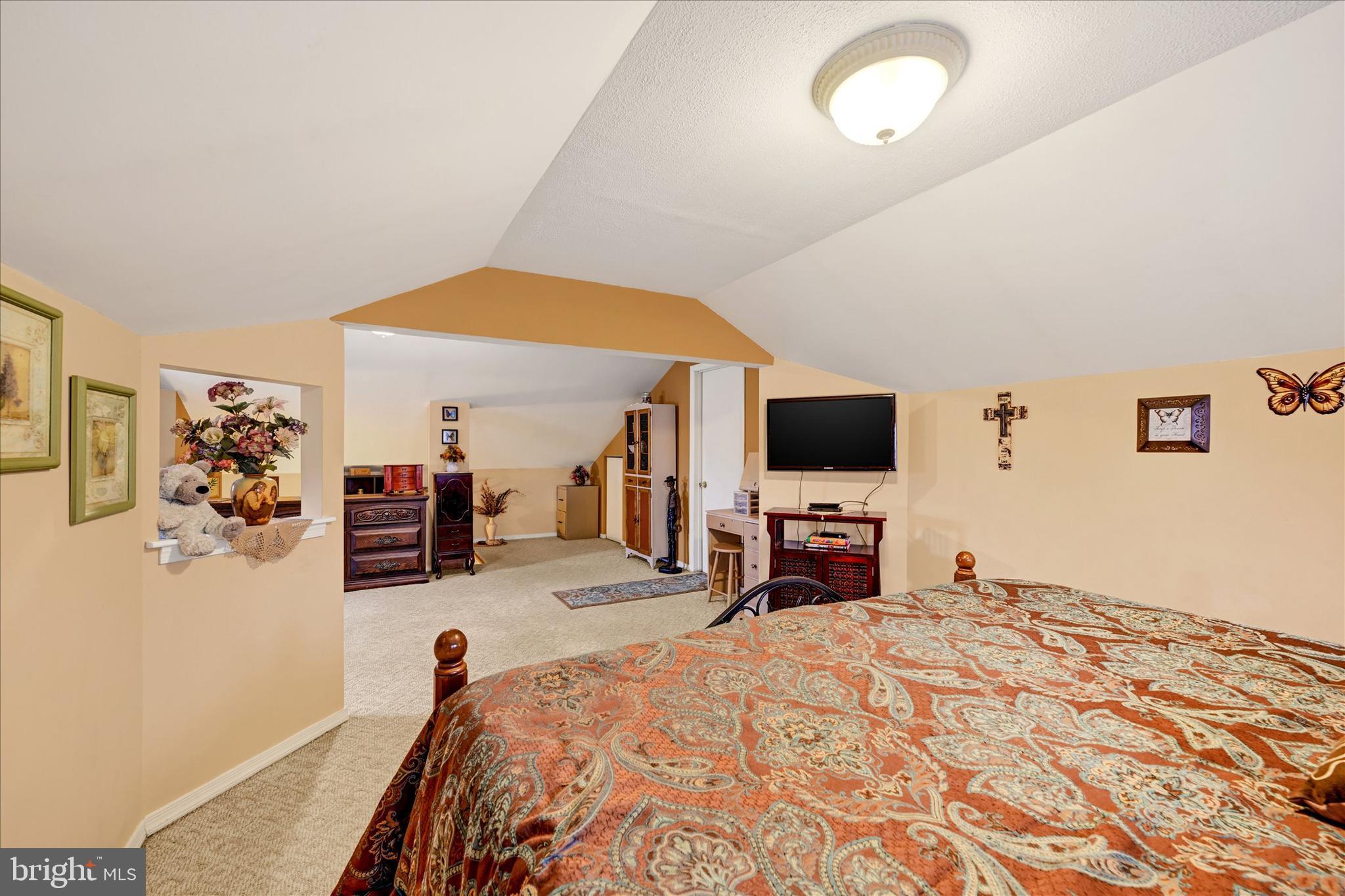 4630 Magnolia Avenue Baltimore, MD 21227 - Photo 22 of 31 a bedroom with a bed and a flat screen tv