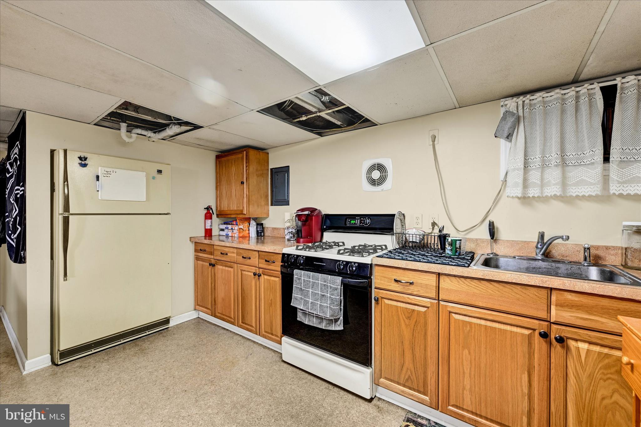 4630 Magnolia Avenue Baltimore, MD 21227 - Photo 25 of 31 a kitchen with cabinets and stainless steel appliances