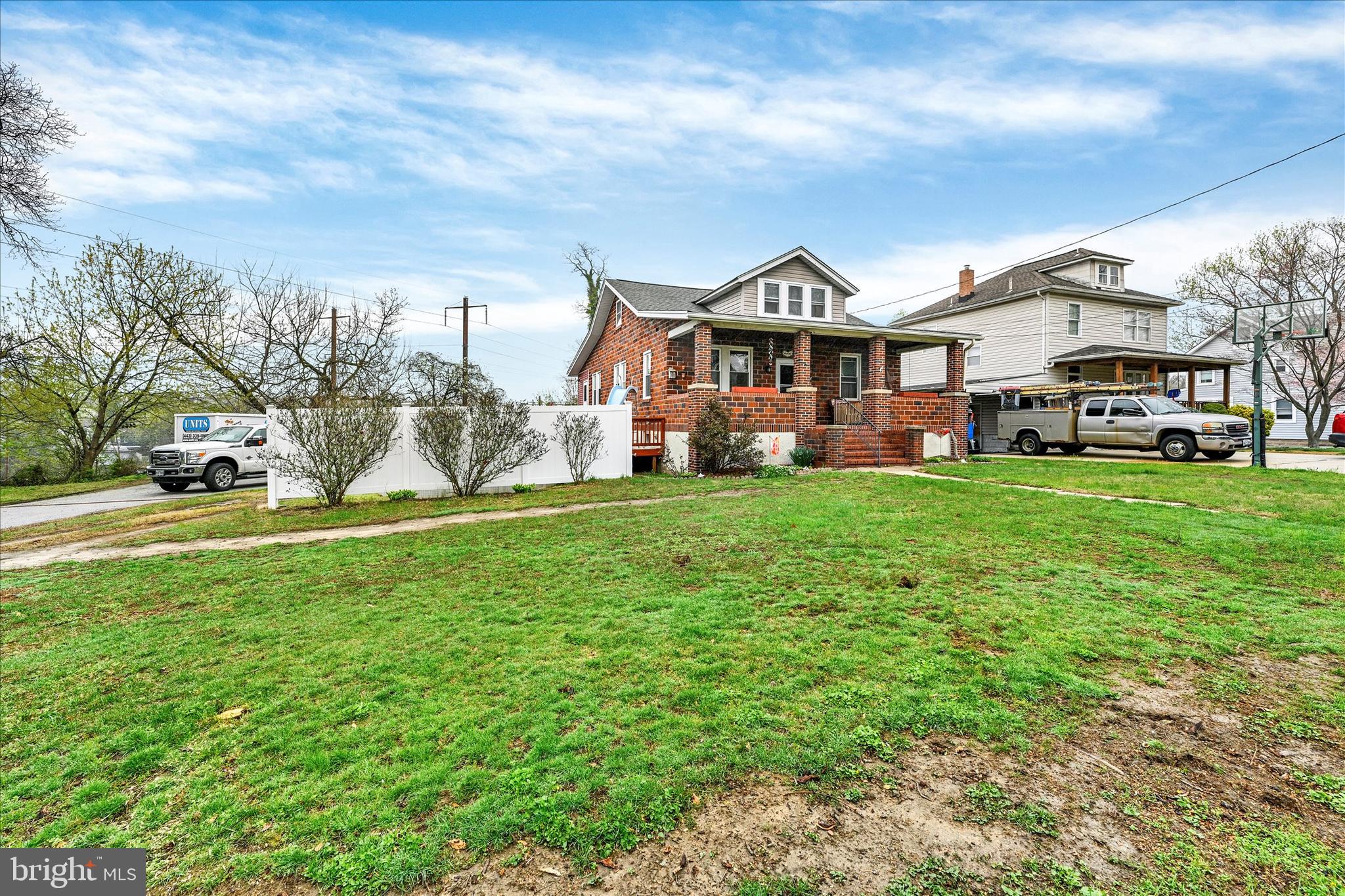 4630 Magnolia Avenue Baltimore, MD 21227 - Photo 4 of 31 a front view of a house with a yard porch and brick wall