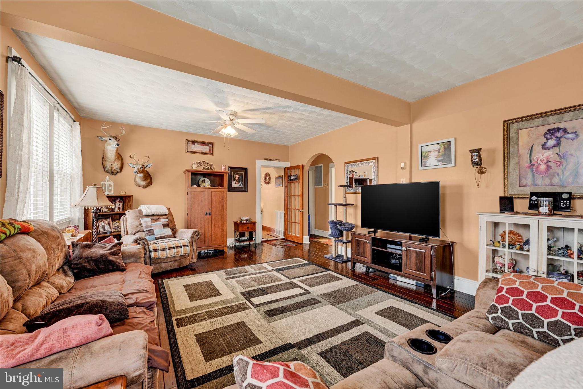 4630 Magnolia Avenue Baltimore, MD 21227 - Photo 6 of 31 a living room with furniture and a flat screen tv