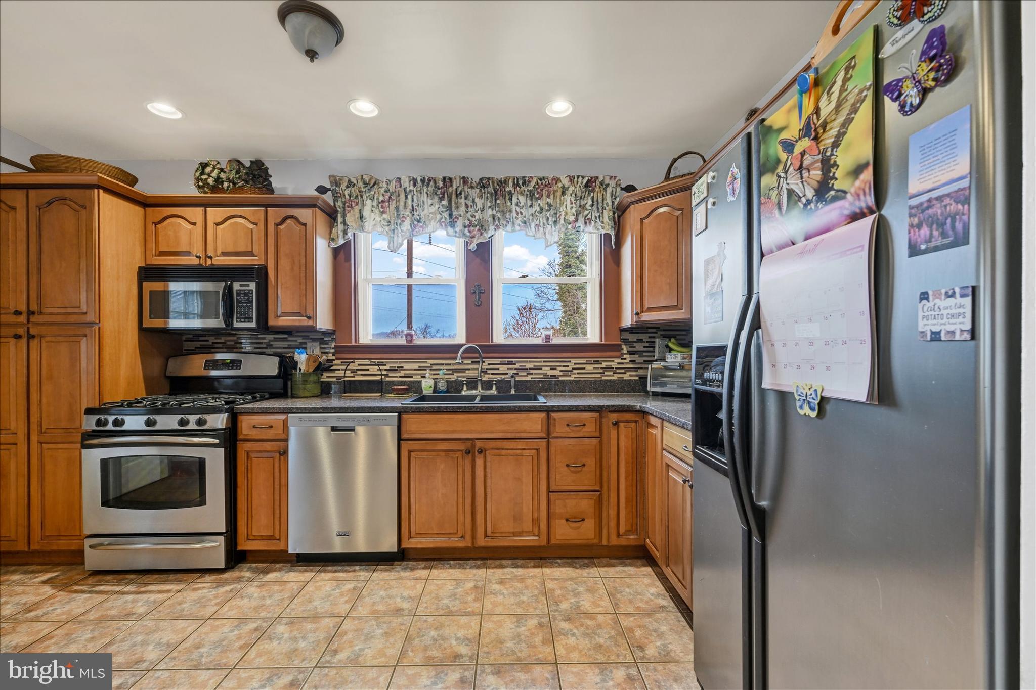 4630 Magnolia Avenue Baltimore, MD 21227 - Photo 10 of 31 a kitchen with stainless steel appliances granite countertop a refrigerator and a sink