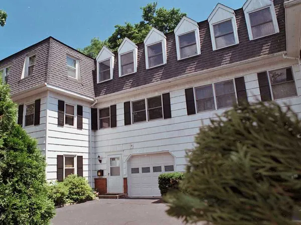 a front view of a building with a garden