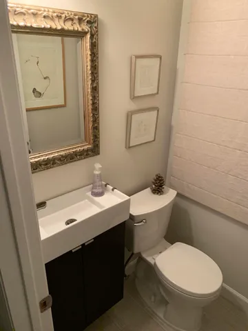 a bathroom with a sink toilet and mirror