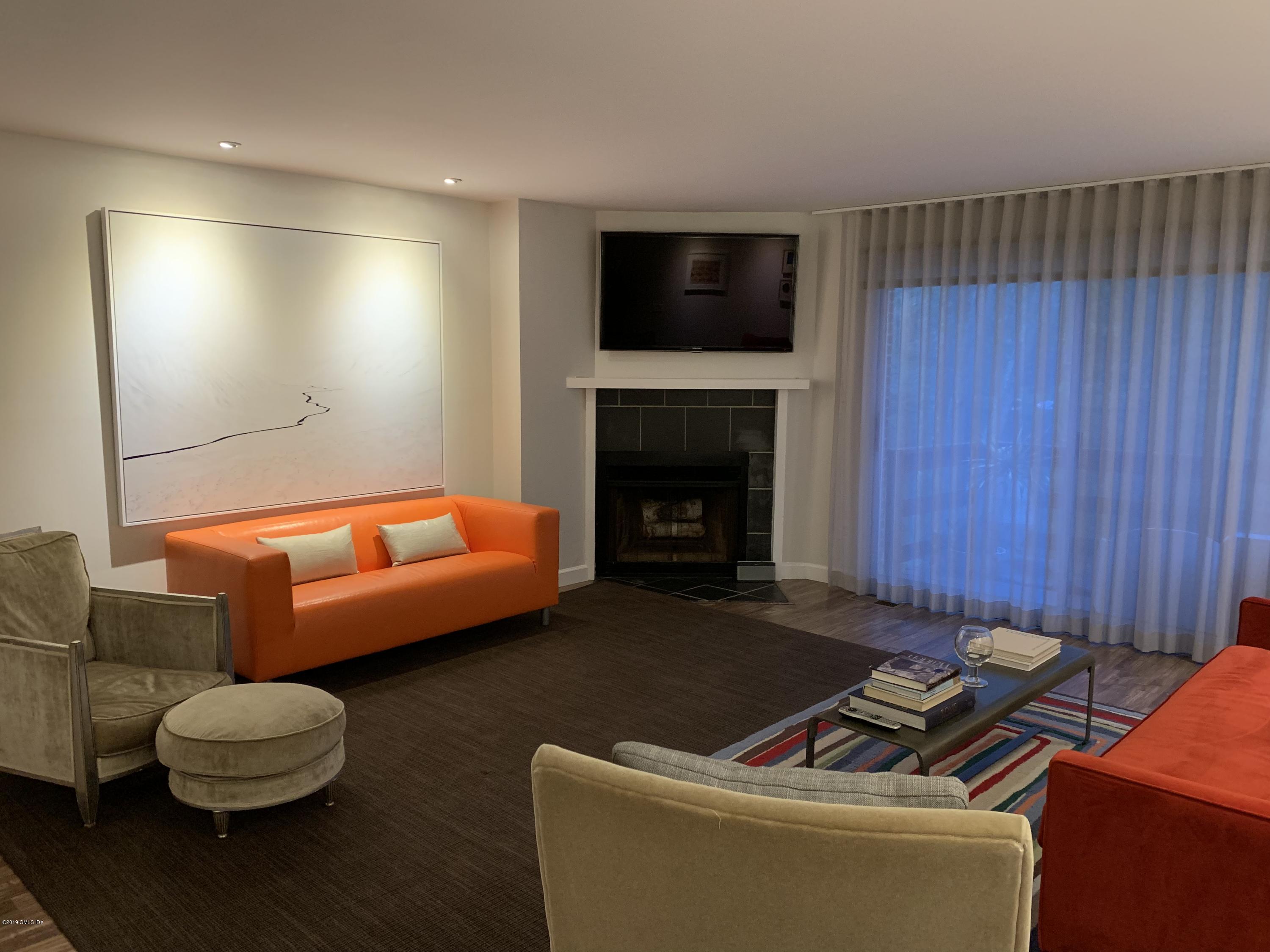 213 River Extension, Unit B Cos Cob, CT 06807 - Photo 5 of 15 a living room with furniture and a fireplace