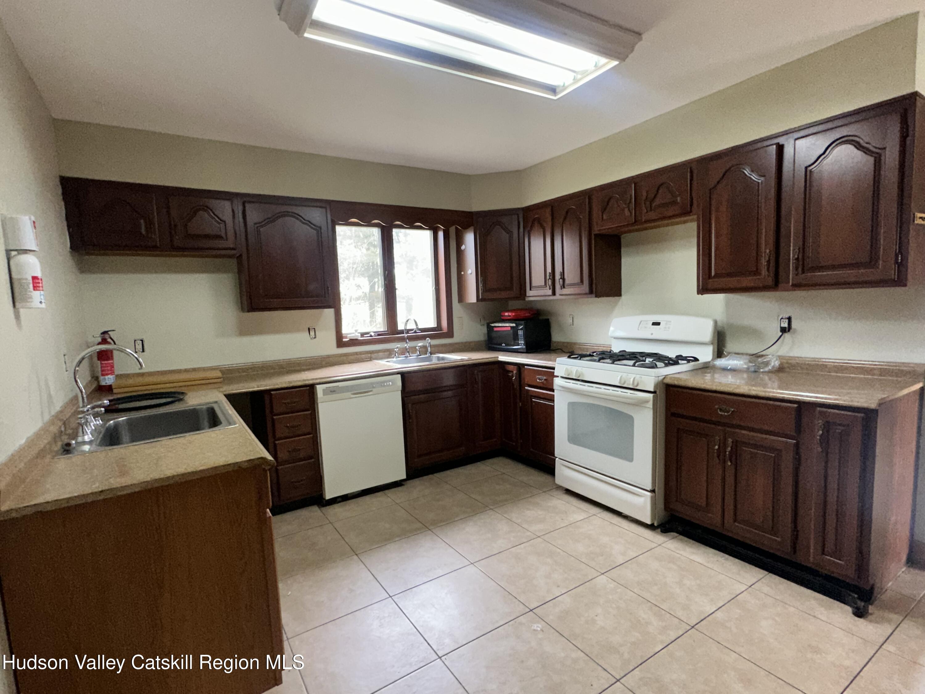 90 Ingalside Road Greenville, NY 12083 - Photo 15 of 36 a kitchen with a stove sink and a microwave