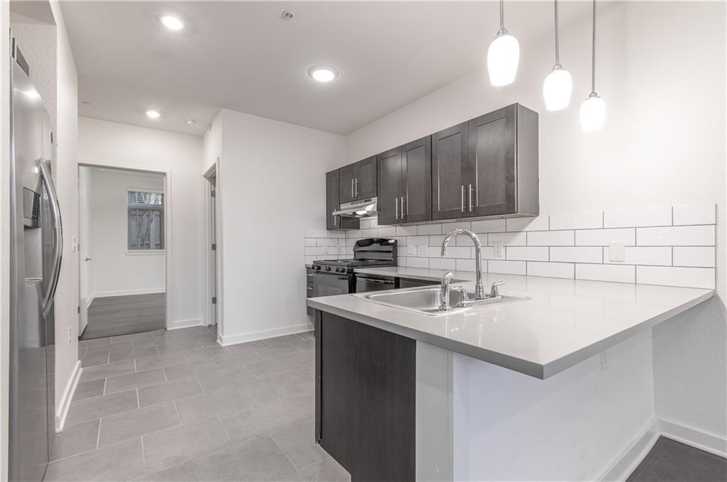 6700 Menchaca Road, Unit 12 Austin, TX 78745 - Photo 11 of 20 a kitchen that has a sink cabinets counter space and appliances