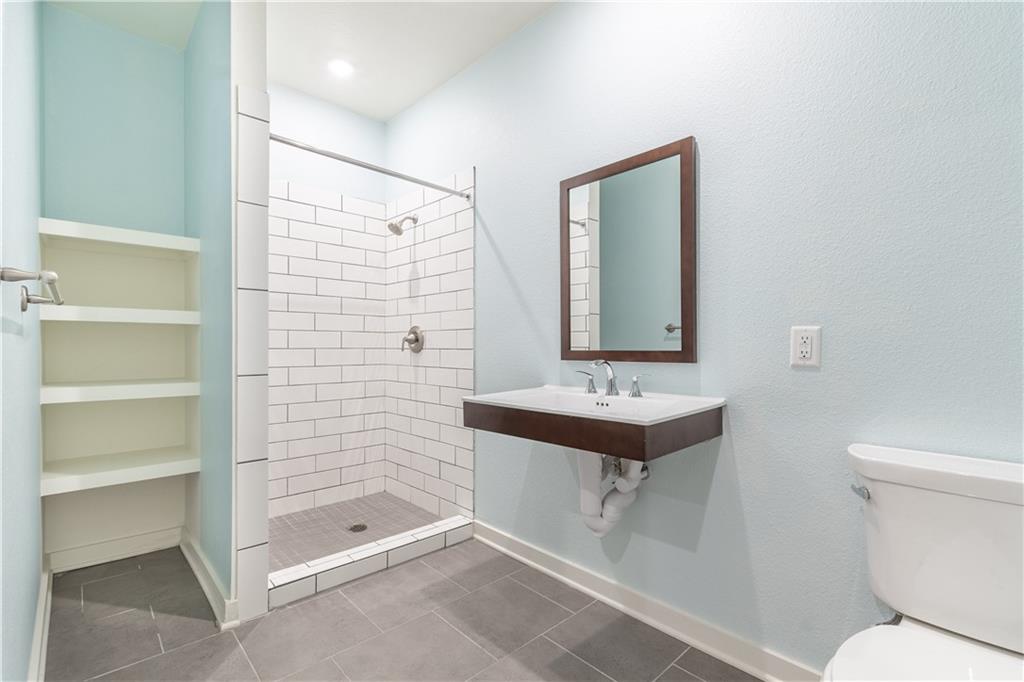 6700 Menchaca Road, Unit 12 Austin, TX 78745 - Photo 13 of 20 a bathroom with a sink a toilet and shower