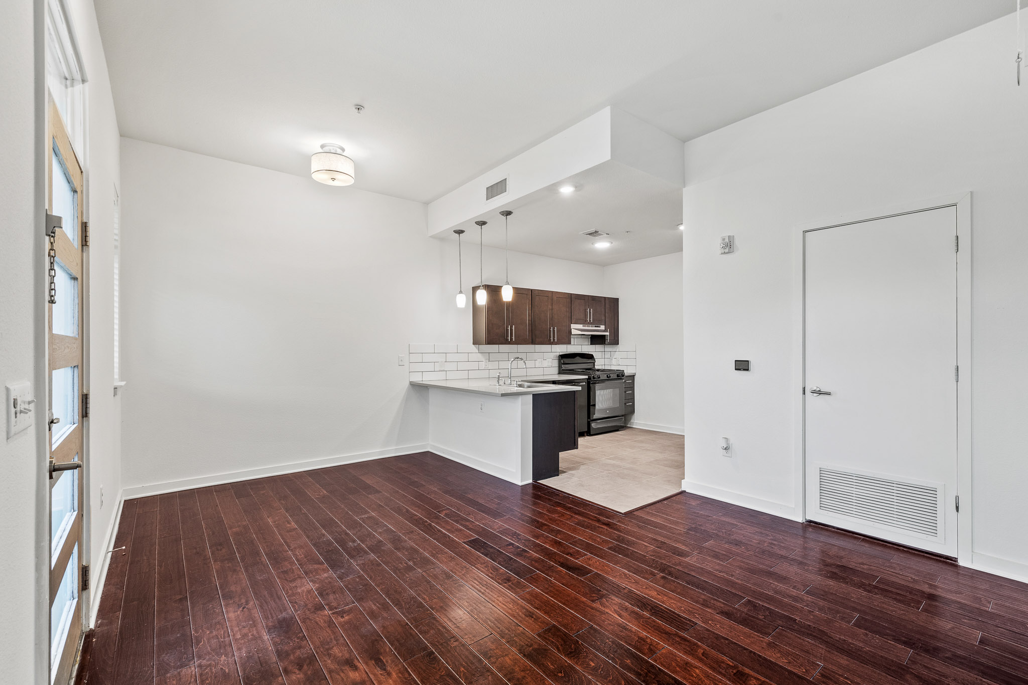 6700 Menchaca Road, Unit 12 Austin, TX 78745 - Photo 3 of 20 a kitchen with stainless steel appliances kitchen island wooden floors and granite counter tops
