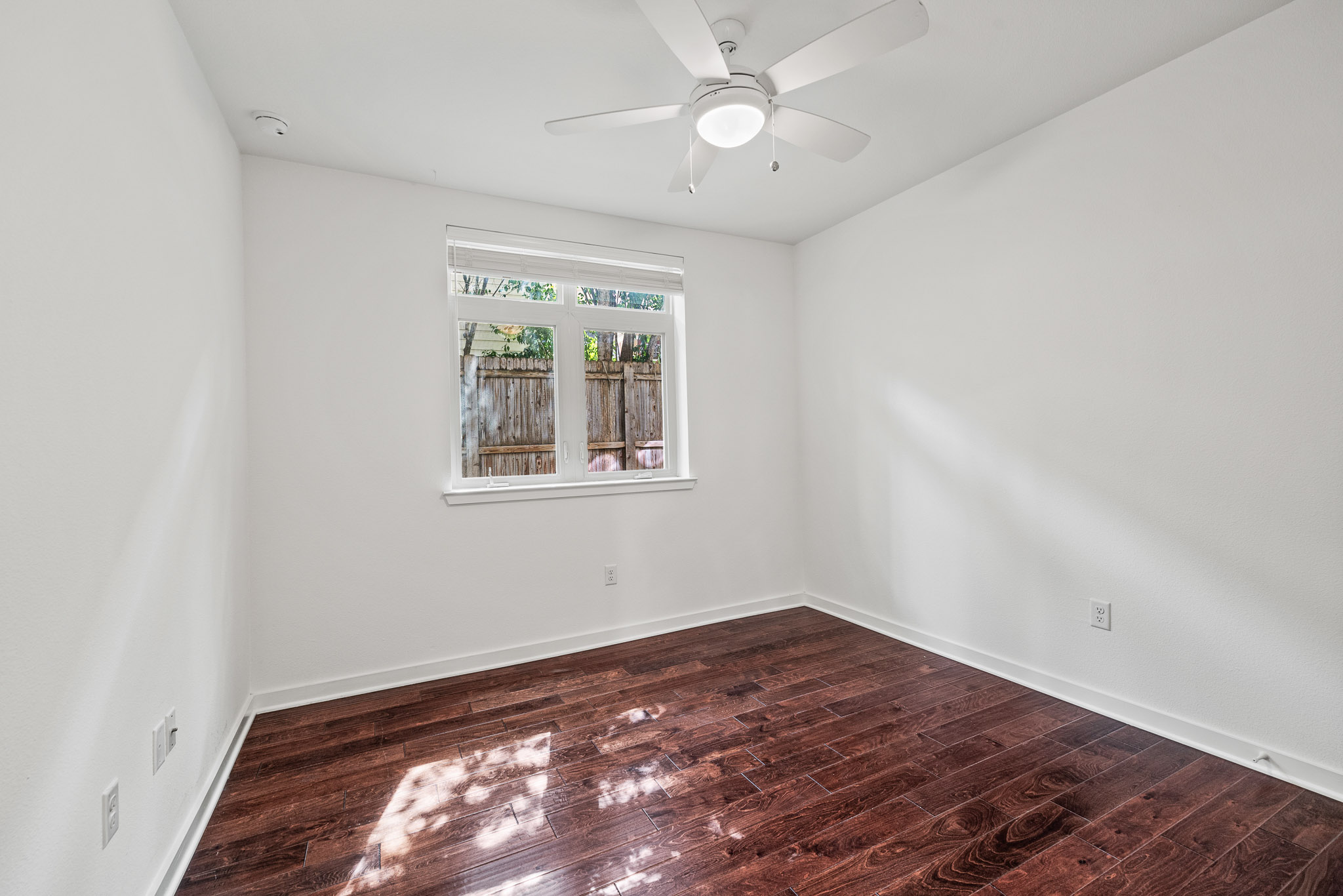 6700 Menchaca Road, Unit 12 Austin, TX 78745 - Photo 6 of 20 wooden floor in an empty room with a window