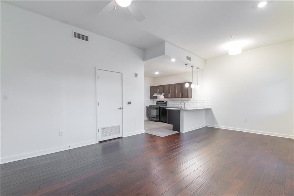 6700 Menchaca Road, Unit 12 Austin, TX 78745 - Photo 9 of 20 a view of kitchen with kitchen island stainless steel appliances refrigerator sink and stove