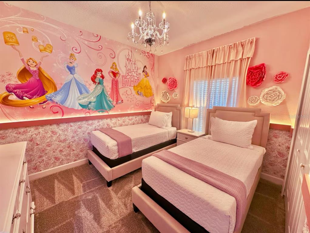 2580 Reading Trail Kissimmee, FL 34746 - Photo 13 of 34 a bedroom with two beds and a painting on the wall
