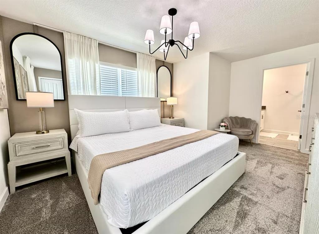 2580 Reading Trail Kissimmee, FL 34746 - Photo 16 of 34 a bedroom with a bed and a chandelier