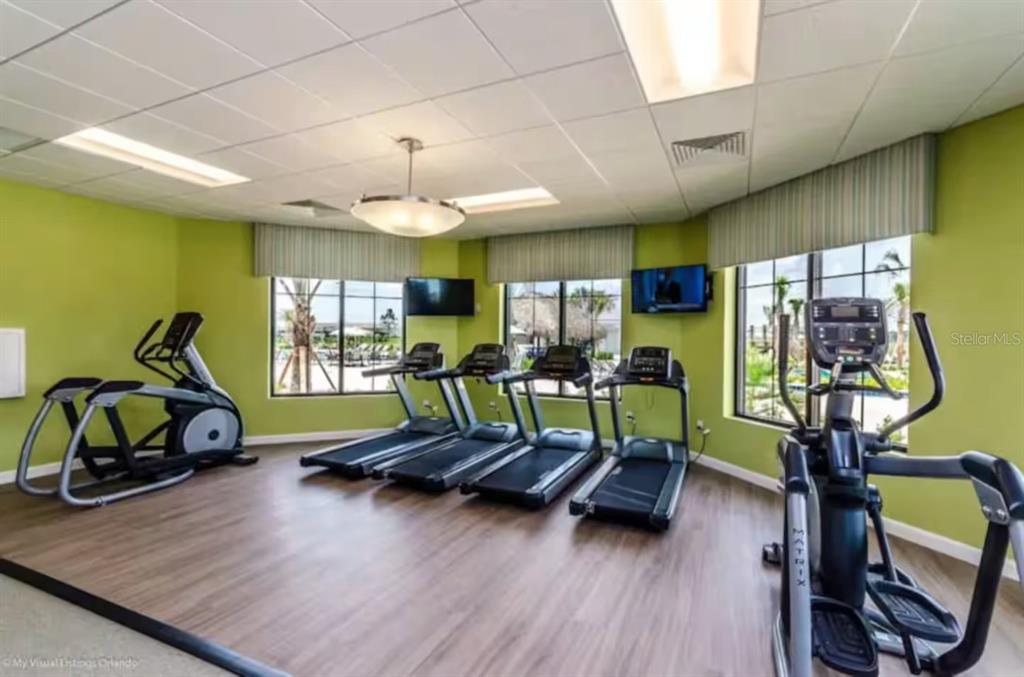 2580 Reading Trail Kissimmee, FL 34746 - Photo 23 of 34 a living room with furniture gym equipment and a large window