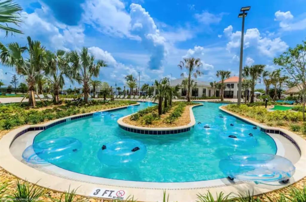 2580 Reading Trail Kissimmee, FL 34746 - Photo 24 of 34 a view of a swimming pool with a yard and outdoor seating