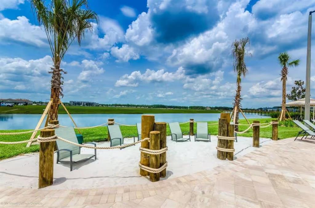 2580 Reading Trail Kissimmee, FL 34746 - Photo 30 of 34 a view of swimming pool with a patio and a garden
