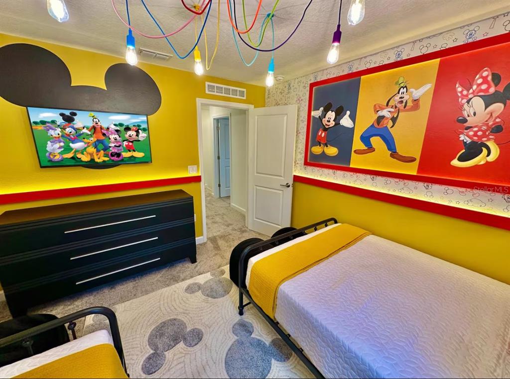 2580 Reading Trail Kissimmee, FL 34746 - Photo 3 of 34 a bedroom with bed and wall painting