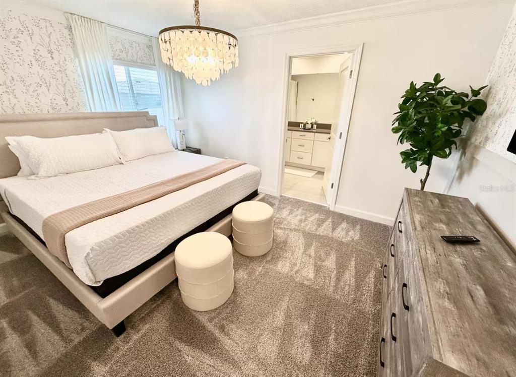 2580 Reading Trail Kissimmee, FL 34746 - Photo 5 of 34 a bedroom with a bed and a potted plant