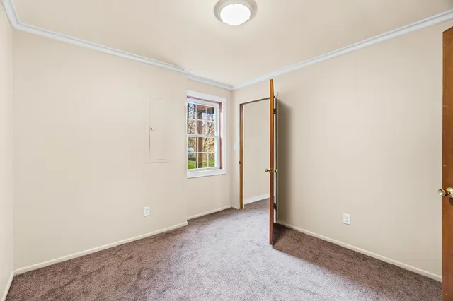 an empty room with windows and closet