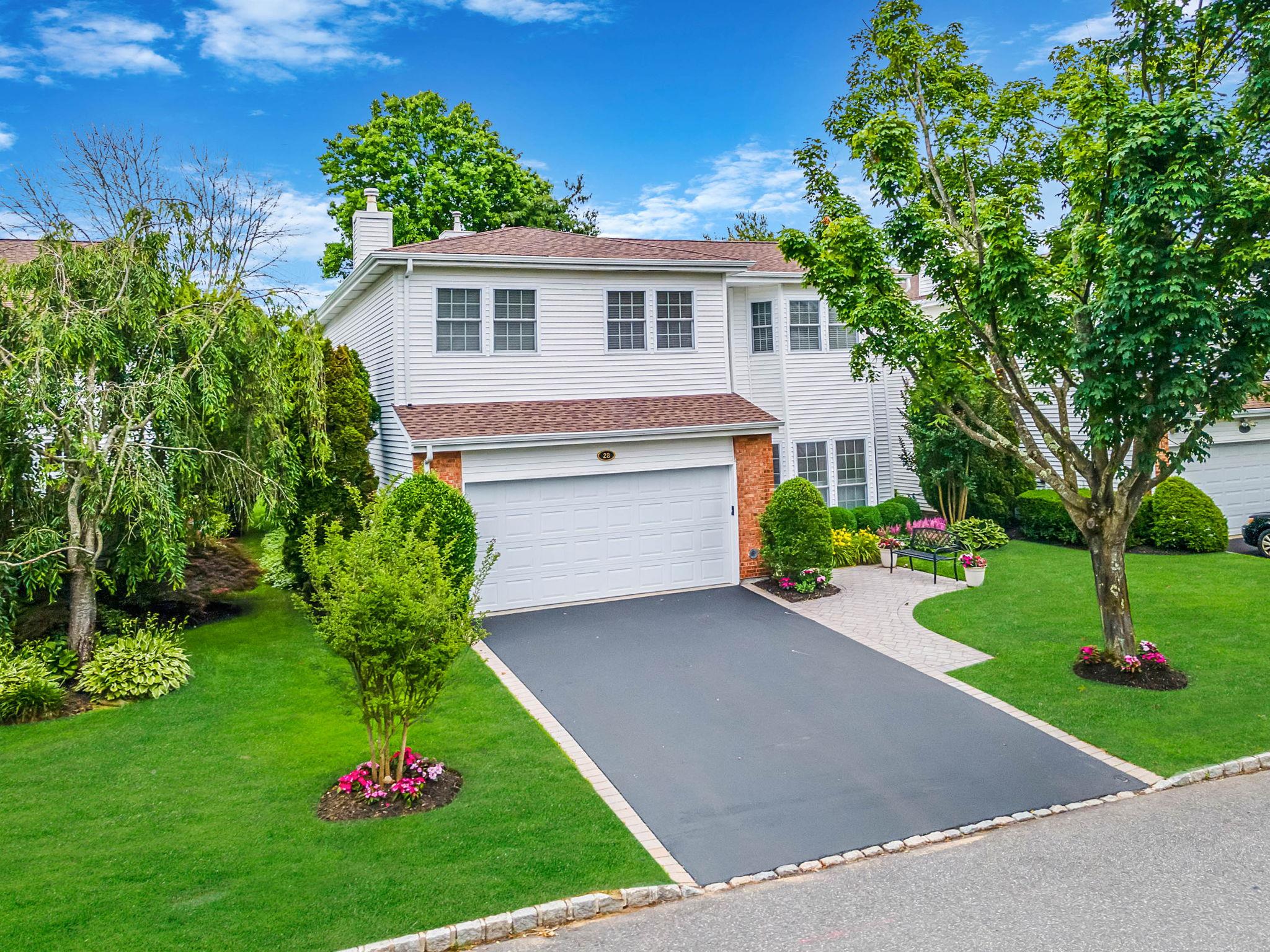 28 Hamlet Drive Commack, NY 11725 - Photo 1 of 1 a front view of a house with a yard and trees
