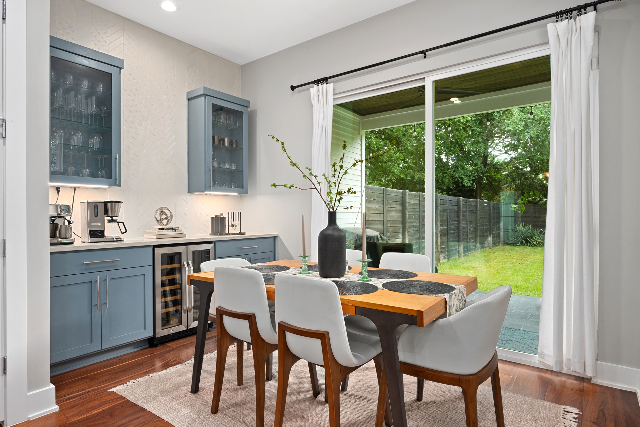 1103 Saucedo Street, Unit 1 Austin, TX 78721 - Photo 21 of 40 Hardwood floors and sleek cabinetry complement this dining area, with immediate backyard access through glass sliders.