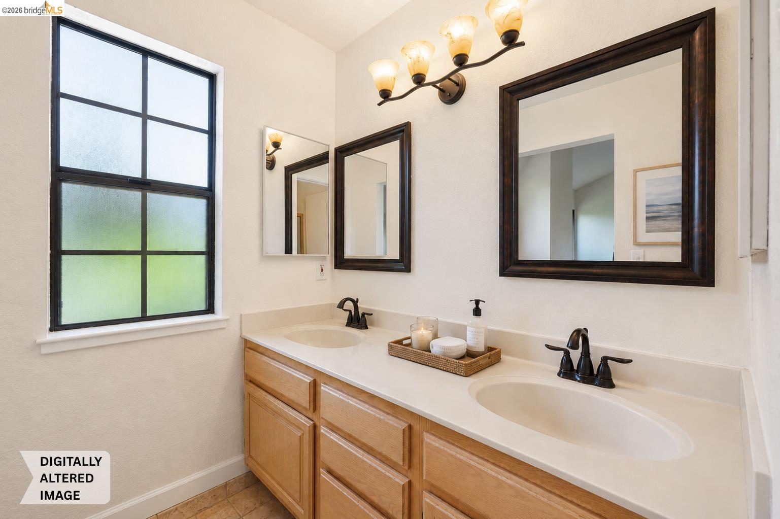 261 Redhawk Road Novato, CA 94949 - Photo 35 of 47 Bathroom featuring a dual vanity with light-toned cabinetry, two undermount sinks, and dark bronze fixtures