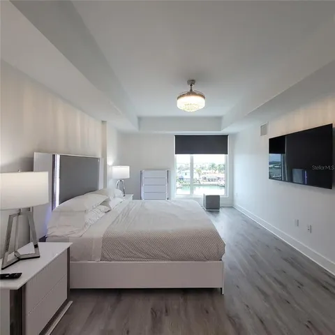 a bedroom with a large bed and a tv