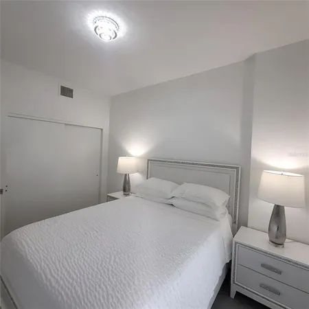 a bedroom with a bed and a lamp