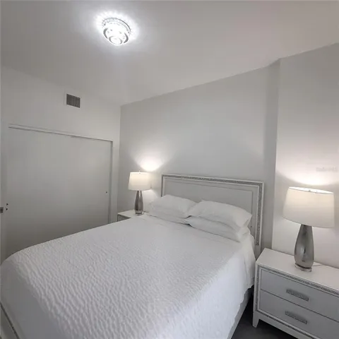 a bedroom with a bed and a lamp