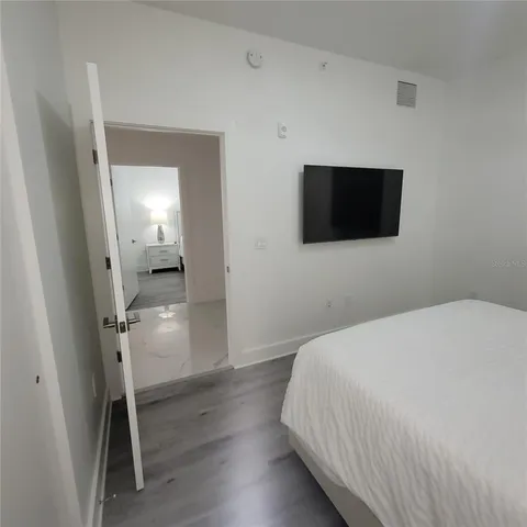 a bedroom with a bed and a flat screen tv