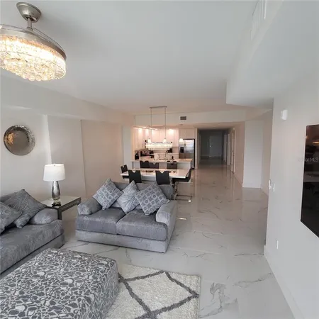 a living room with furniture and a large mirror