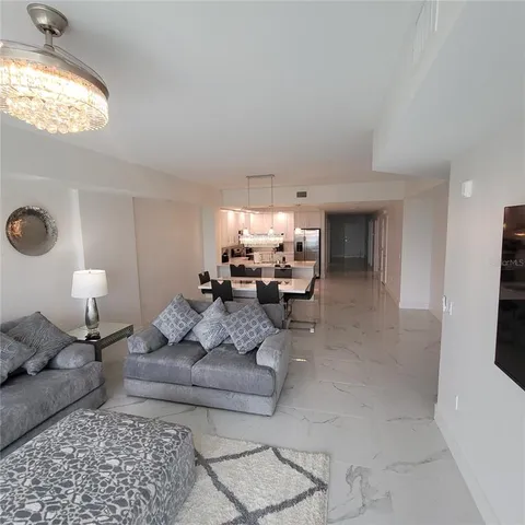 a living room with furniture and a large mirror