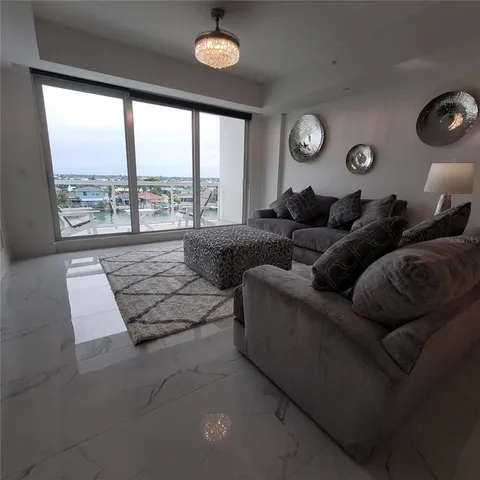 a living room with couches and a large window