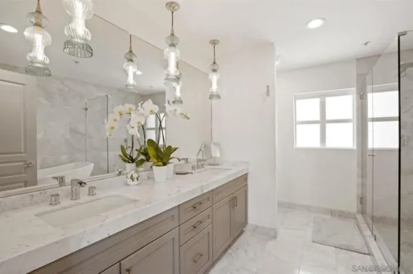 a bathroom with a sink double vanity and a mirror