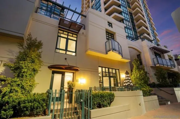 front view of a multi story building with a yard
