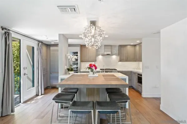 a view of a dining room with furniture and a chandelier