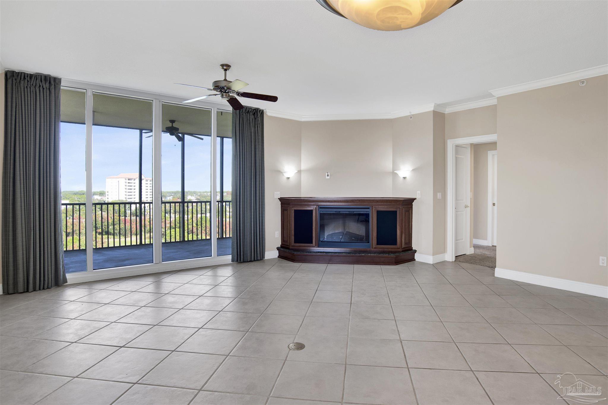 608 Lost Key Drive, Unit 701C Pensacola, FL 32507 - Photo 16 of 32 a view of an empty room with a fireplace and a window